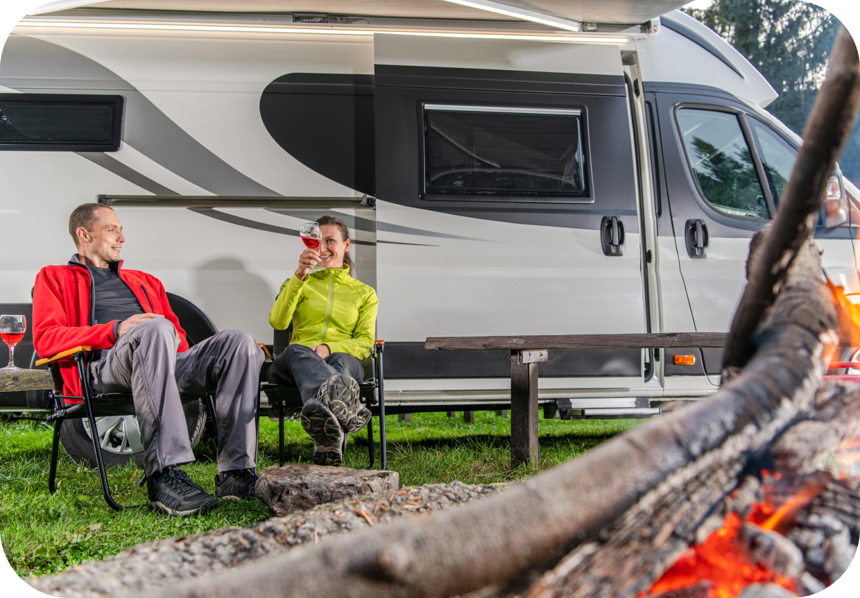 GettyImages-1346257872 Two people relaxing by a camper van.