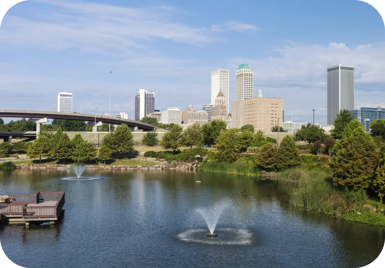 GettyImages-1791194070 City skyline with park and water fountains.