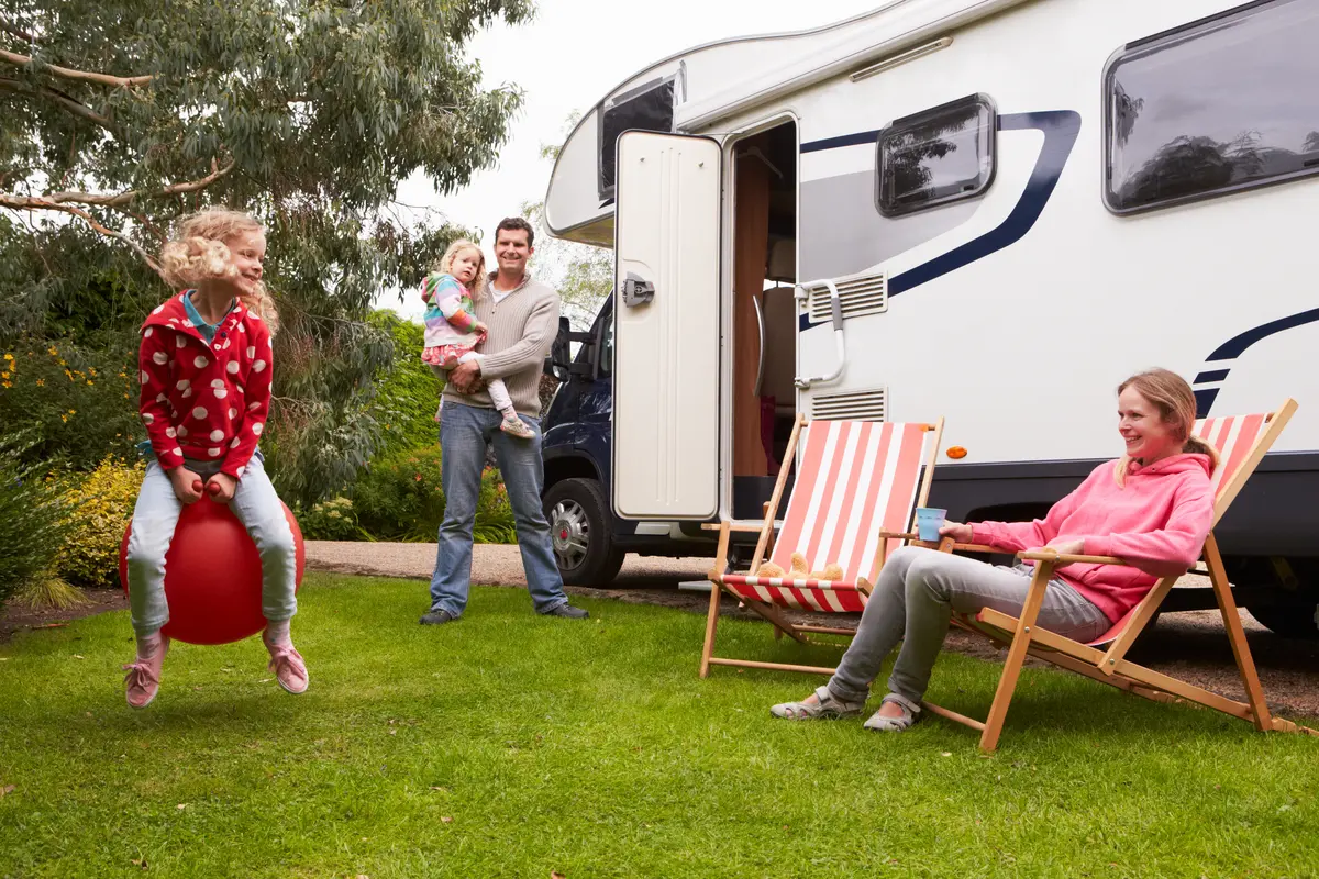 Family enjoying time outside their camper van.